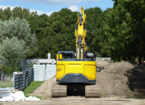 An excavator near a pile of dirt